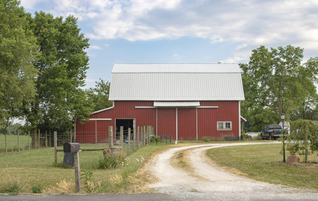 classic-red-barn-with-gravel-driveway-2024-10-18-05-39-26-utc